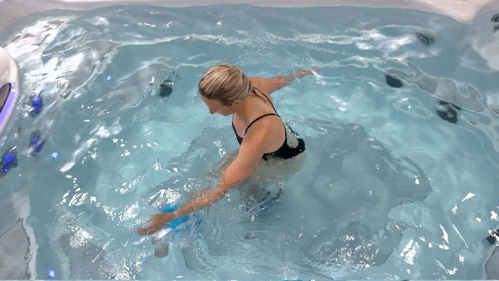 woman is exercising in swim spa