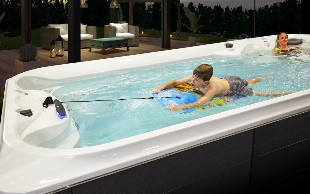 a boy is swimming in jacuzzi swim spa